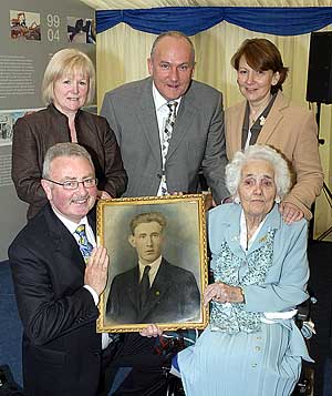 Family members holding a photograph of Mick Synnott who was killed in 1925 at the valley works.