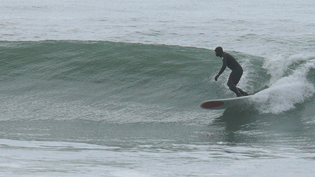 Surfer at Tywyn beach by Darren Grady