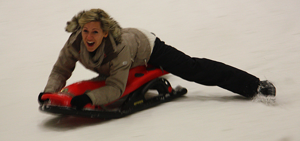Naomi Wilkinson sledging down a slope