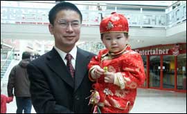 Chinese boy in traditional costume with father 