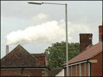 Houses with smoke behind them