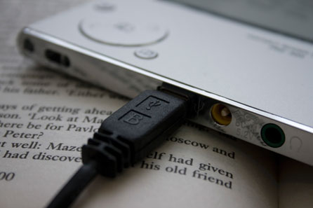 An ebook reader on top of a paperback