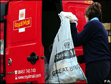 Royal Mail worker collecting postbag from a van