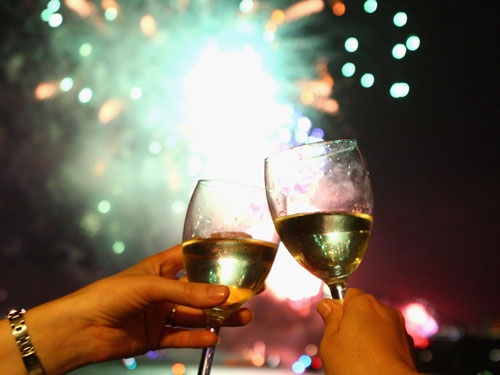 Champaign glasses with fireworks in the background