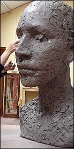 Caro working on a large clay head