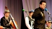 Kevin Bridges performing with The Tiger Lillies watching on