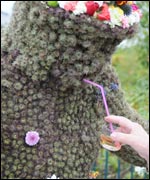 The Burryman receiving a whisky during his long tour.