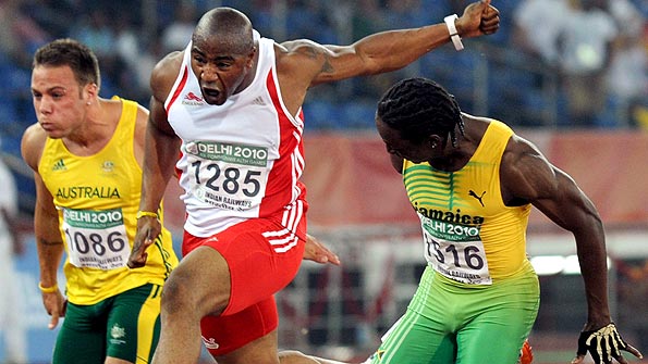 Jamaican Lerone Clarke pips England's Mark Lewis-Francis for the 100m gold in Delhi