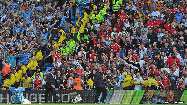 Adebayor celebrates his goal for Man City by running to the Arsenal fans