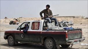 Libyan rebels wait at a checkpoint in Brega