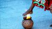 A female foot being dipped on a bowl of fire
