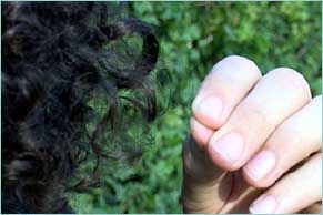 Person pulling a hair out of their head