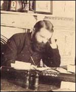 Silvanus Trevail sitting at a desk