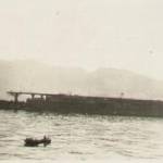 Japanese aircraft carrier being towed into Kure harbour for scrap.