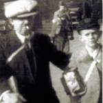 Dennis Pell with grandfather Frederick Francis Pell, carrying their gas masks