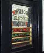 An engraved door into the pub
