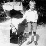 Big brother John Hill puts a protective hand on baby Rita's pram in Birmingham 1944