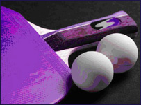 A table tennis bat and two balls