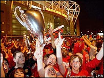 United fans celebrate outside Old Trafford (c) PA