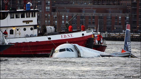Rescue boats float next to a US Airways plane after it crashed into the Hudson River.