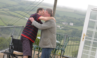Ray stands to greet Simon