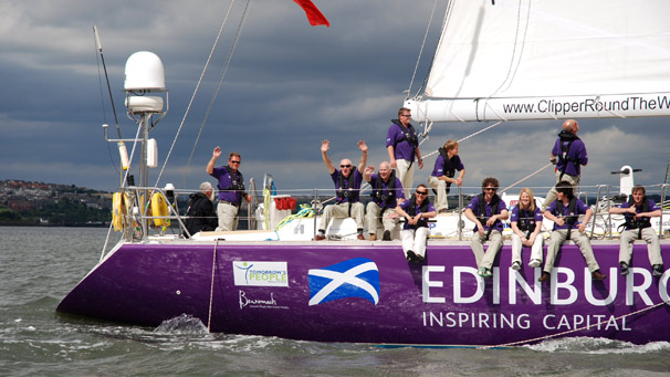 Edinburgh Inspiring Capital crew and skipper give a wave to the camera on the way to the ship's official naming ceremony