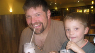 Laurence Clark and his son Tom enjoying an icecream sunday in a restaurant