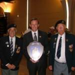7 June 2004. Jim Jolly (right) and Pat Kelly (left) present a Shield with the Coat of Arms of Workington, Cumbria to the Mayor of Bayeux, Calvados, France, Mr Patrick Gomont.