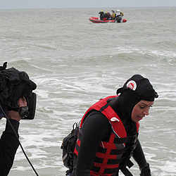 Christine wading ashore onto a beach in France