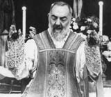 Padre Pio leading a service in priestly robes with coverings over the palms of his hands. Image credit: Padre Pio Devotions