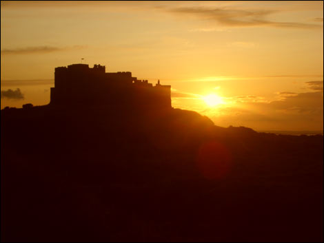 Sun behind Bamburgh Castle. Photo: Michael Chaplain