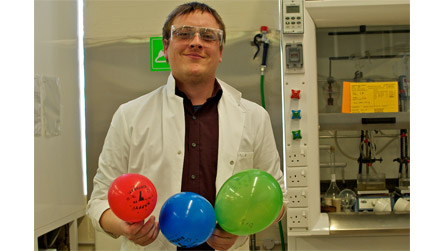 Dr Tom Davies with gas filled balloons