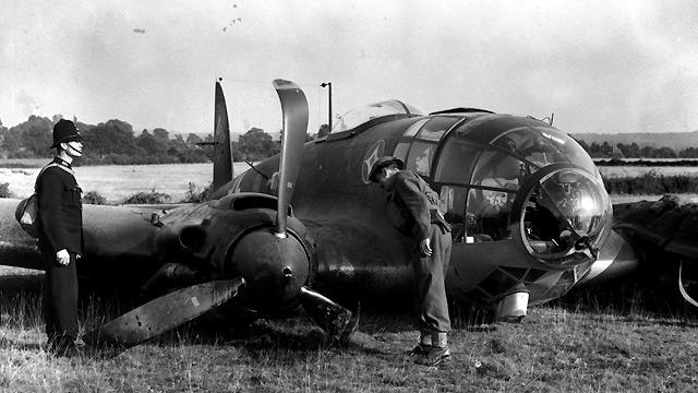 A policeman and soldier inspect a German Heinkel HE-111 which crashed during an attack on Biggin Hill on 30 August 1940.