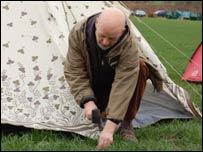 Michael Eavis putting in tent pegs