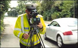 Officer using laser detection equipment.