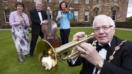 Launching this year's BBC Proms in the Park in the grounds of Hillsborough Castle, are, from left, Councillor Jenny Palmer (Lisburn City Council); BBC Proms in the Park presenters Noel Thompson and Claire McCollum and Councillor Allan Ewart, Mayor of Lisburn