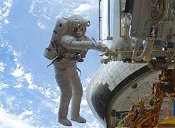 An astronaut working on the NCS radiator outside of Hubble in space (credit: NASA)