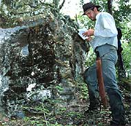 Marc Zender examines a building at Naachtun