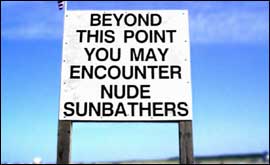 Sign saying 'Beyond this point you may encounter nude sunbathers'