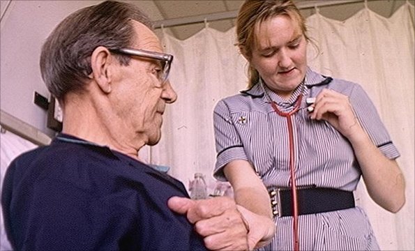 A nurse checks on a patient