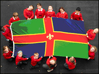 Pupils from Monks Abbey Primary holding the flag
