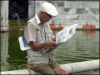 Elderly man reading newspaper