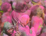 People celebrating Holi by dousing each other with coloured powder and water
