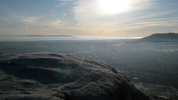 Sunshine picks out paths in the white frost covering Arthur's Seat