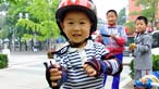 A child wearing a cycle helmet