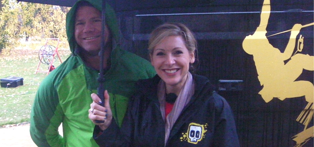 Steve Backshall and Naomi Wilkinson standing under an umbrella