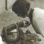 The picture is demonstrating a special gas mask made for babies. The baby inside is me and the lady is my mother. The demonstration was at St Cleer, near Liskeard.