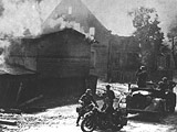 Motorized units survey the result of a 'Luftwaffe' attack, Poland