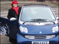 Joanne Rainbow by the electric car