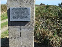 The plaque on the gate post
